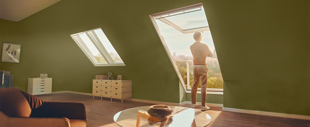 Man looking out his VELUX roof window